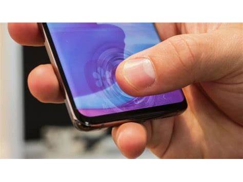 A hand holding a smartphone with a fingertip on the in-display ultrasonic fingerprint area.