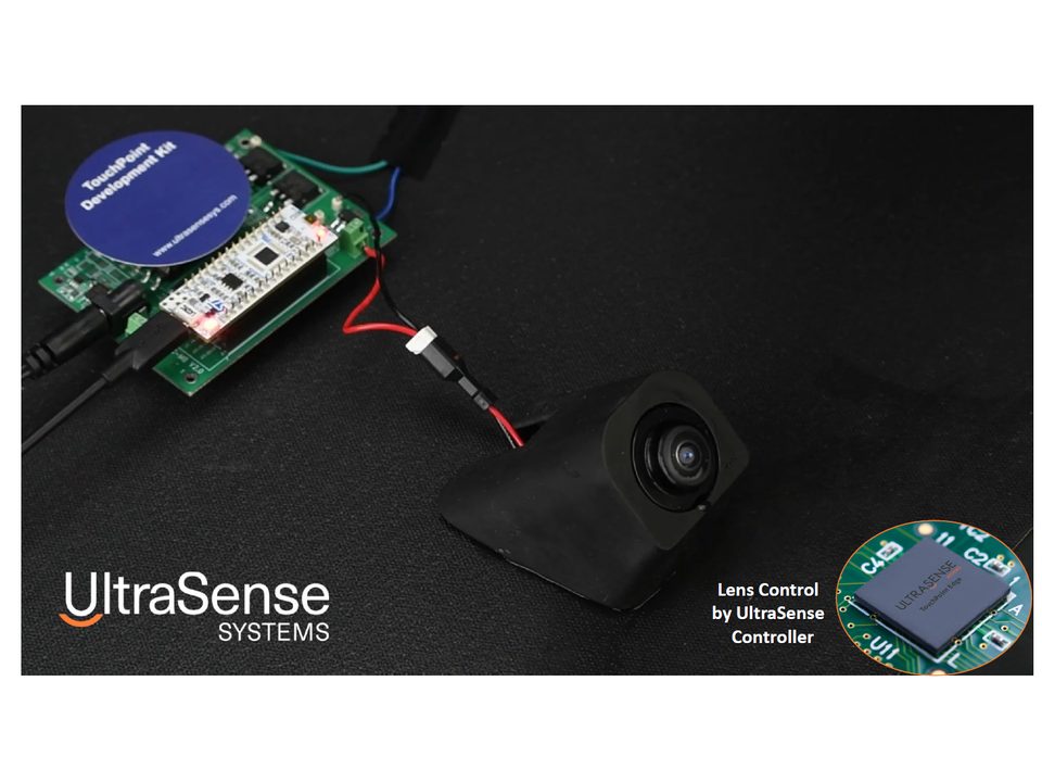 The UltraClear prototype board: a green controller board wired to a camera lens module with its piezo cleaning ring.